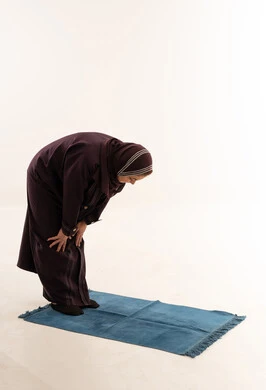 امرأة مسلمة تؤدي ركن الركوع في الاستوديو