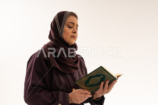Muslim Saudi Woman Reading Quran on White Background