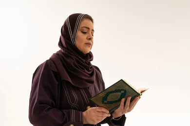 Muslim Saudi Woman Reading Quran on White Background