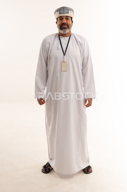 Omani Man in Traditional Dishdasha with ID Badge