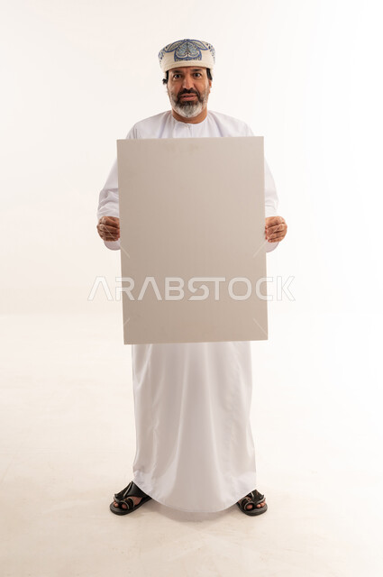 Omani Man Holding Blank White Board in Studio