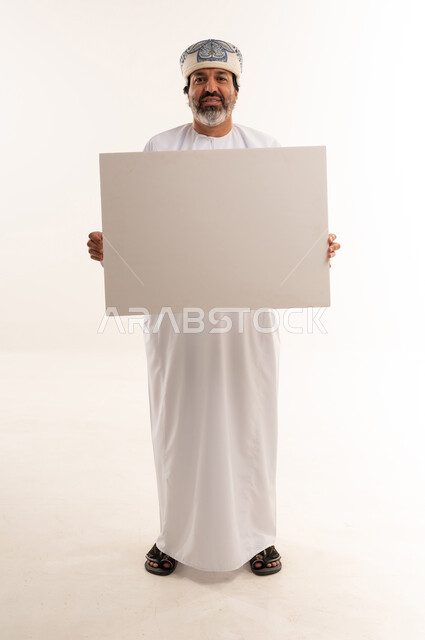 Omani Man Holding Blank White Board in Studio