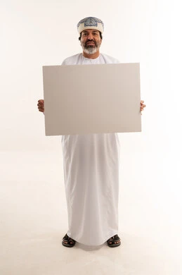 Omani Man Holding Blank White Board in Studio