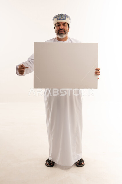 Omani Man Holding Blank Sign on White Background