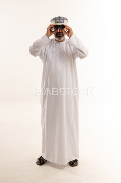 Omani Man in Traditional Dishdasha with Binoculars