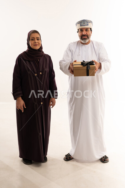Omani Couple with Gift Box on White Background