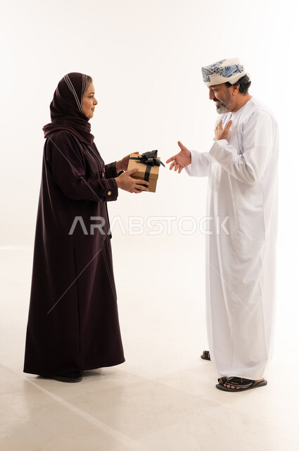 Omani Couple Exchanging Gift in Traditional Clothing