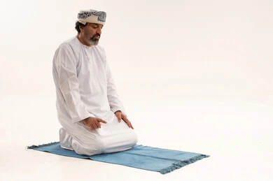 Omani Man Praying Tashahhud on White Background