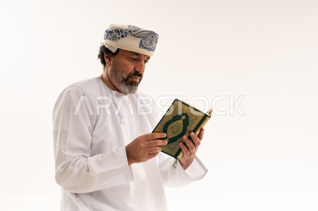 Omani Man Reading Holy Quran on White Background