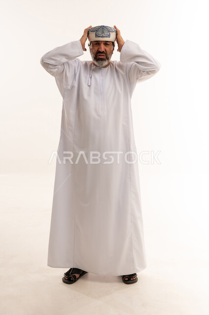 Stressed Omani Man in Traditional Dress on White Background