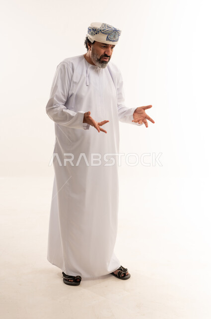 Omani Man in Traditional Dishdasha Gesturing in Studio