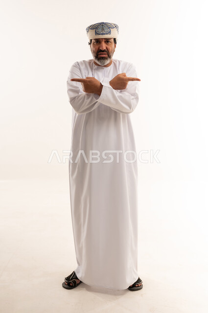 Omani Man Pointing in Opposite Directions Studio Shot