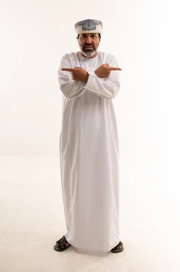 Omani Man Pointing in Opposite Directions Studio Shot