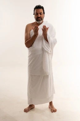 Arab Man in White Ihram Praying on White Background
