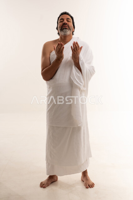 Muslim Man in Ihram Praying on White Background