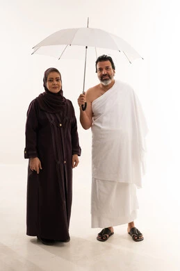 Saudi Couple in Ihram with White Umbrella Studio Shot