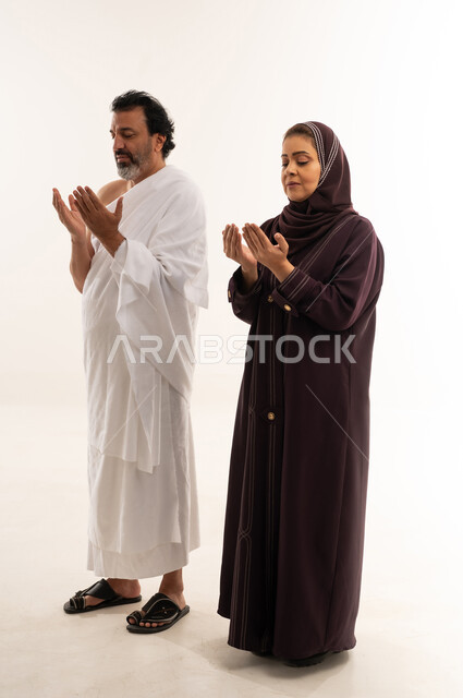 Arab Couple Praying in Ihram and Abaya