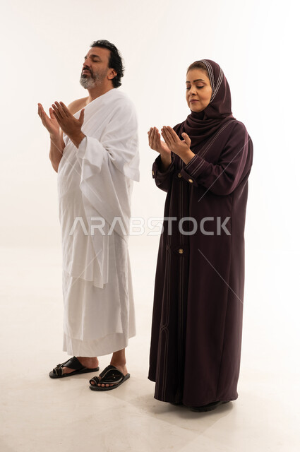 Muslim Couple in Ihram and Abaya Praying Dua