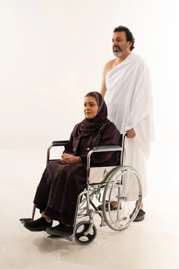 Saudi Man in Ihram with Woman in Wheelchair