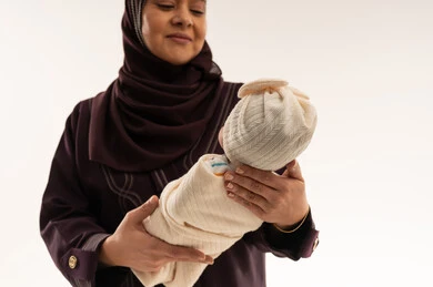Arab Mother Holding Newborn Baby in Studio