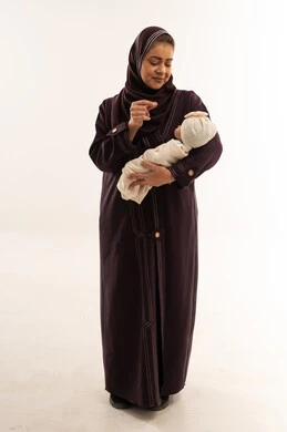 Saudi Mother Holding Newborn Baby in White Studio