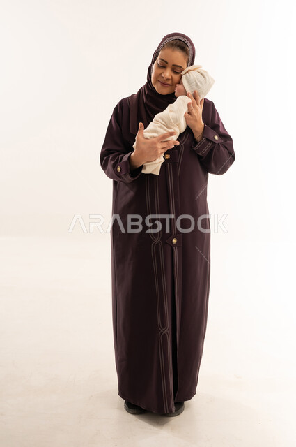 Saudi Woman Holding Newborn Baby in Abaya Studio