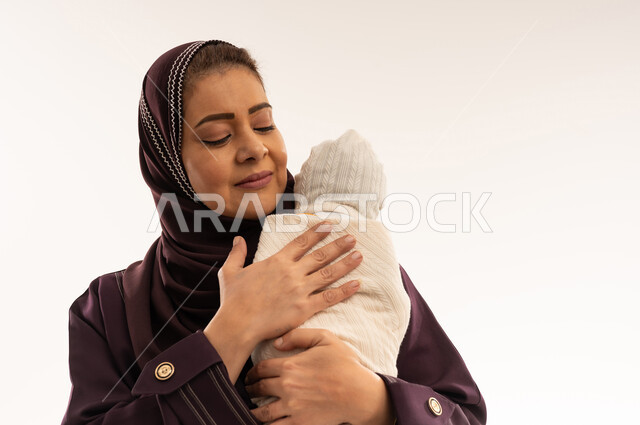 Saudi Mother Holding Swaddled Newborn Baby White Background