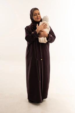 Arab Mother Holding Newborn Baby in Studio Setting
