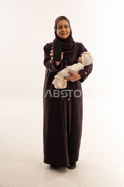 Saudi Woman with Newborn Holding Smartphone Blank Screen