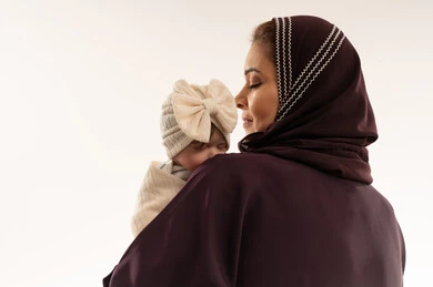 أم عربية تحمل طفلها الرضيع في الاستوديو