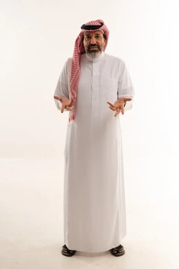 رجل سعودي بالثوب التقليدي يشير بيديه على خلفية بيضاء