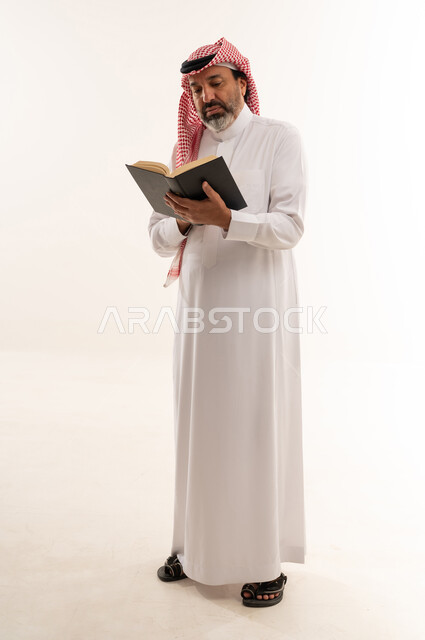 Middle Aged Saudi Man Reading Book on White Background