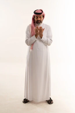 Saudi Man in Traditional Attire Praying on White Background