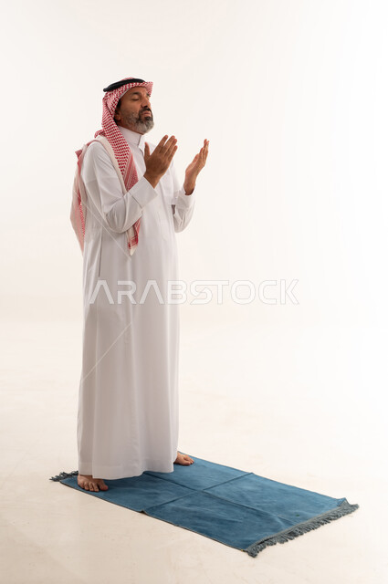 Saudi Man Praying on Mat with White Background