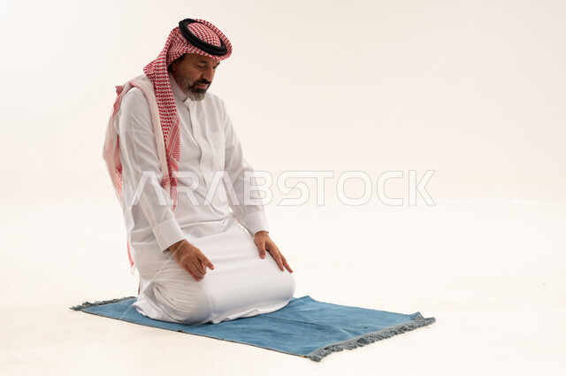Saudi Man Performing Tashahhud Prayer on White Background