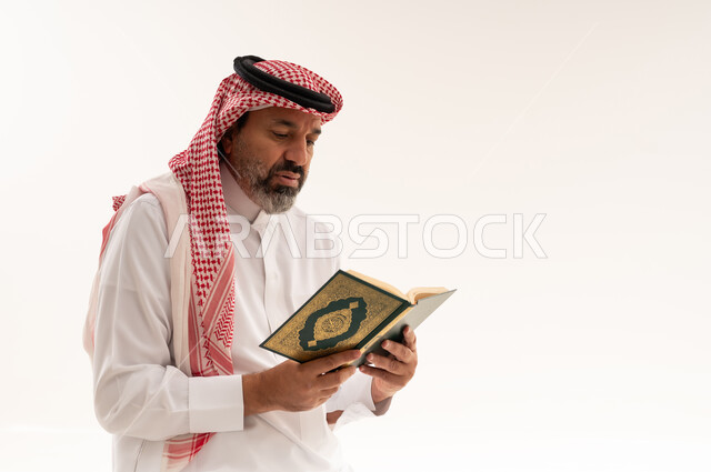 Saudi Man Reading Holy Quran on White Background