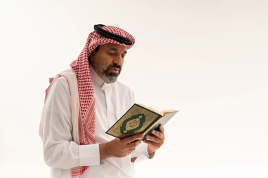 Arab Man Reading Holy Quran in Traditional Saudi Attire
