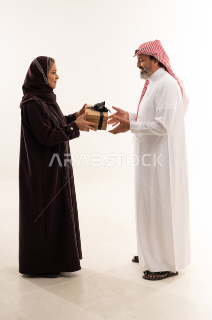 Saudi Couple Exchanging Gift in Studio Setting
