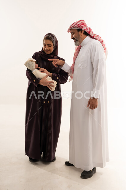 Saudi Couple Holding Newborn Baby in Studio