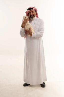 Saudi Father Holding Newborn Baby in Traditional Dress