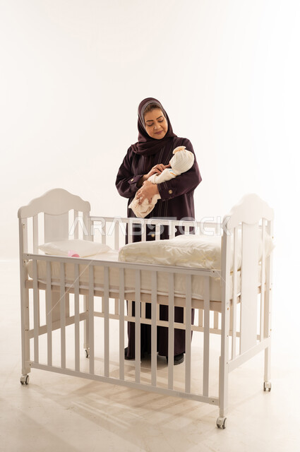 Saudi Mother with Newborn Baby at White Crib