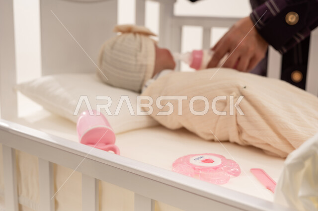 Newborn Baby Bottle Feeding in White Crib