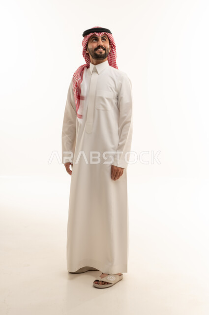 Saudi Man in Traditional Thobe Looking Upwards