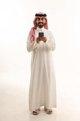 Saudi Man in Thobe Using Smartphone on White Background