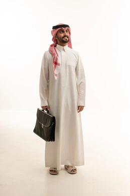 رجل اعمال عربي سعودي خليجي يرتدي الزي الثوب الابيض والشماغ ويحمل حقيبة اللابتوب, ايماءات واشارات مختلفه , كامل الجسم, خلفيه بيضاء