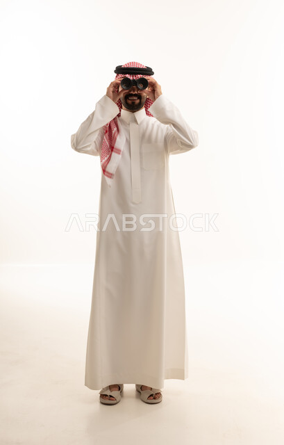 Saudi Man in Thobe Looking Through Binoculars