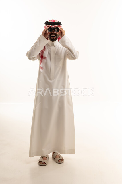 Saudi Man in Traditional Thobe Looking Through Binoculars