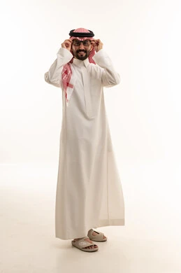 Saudi Man in Traditional Thobe Adjusting Glasses