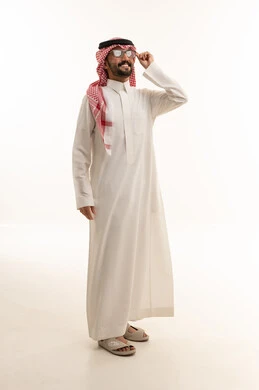 رجل سعودي بالثوب التقليدي والنظارات الشمسية في استوديو