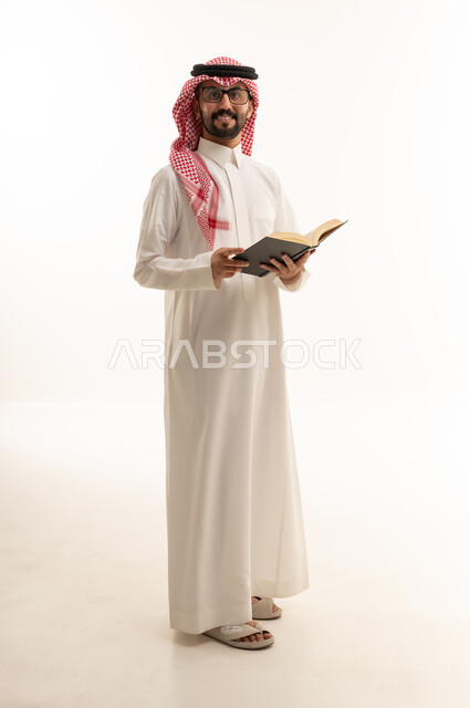 Saudi Man in Traditional Thobe Holding Book